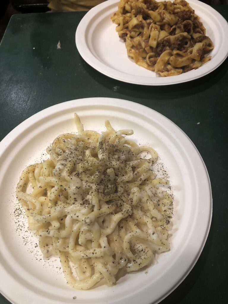 Cacio e pepe pasta served in Rome, featuring Pecorino Romano cheese and freshly ground black pepper.
