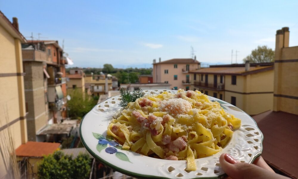 Traditional spaghetti carbonara served in Rome with guanciale, Pecorino Romano cheese, and black pepper.