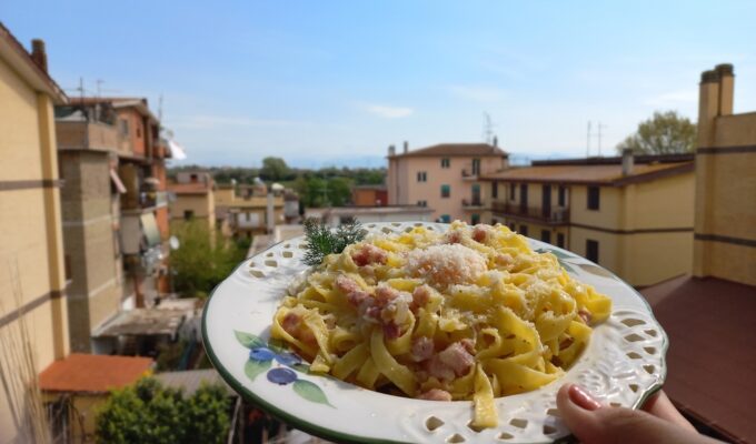Traditional spaghetti carbonara served in Rome with guanciale, Pecorino Romano cheese, and black pepper.