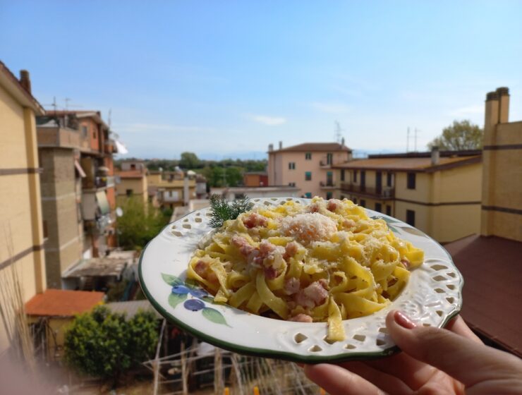 Traditional spaghetti carbonara served in Rome with guanciale, Pecorino Romano cheese, and black pepper.