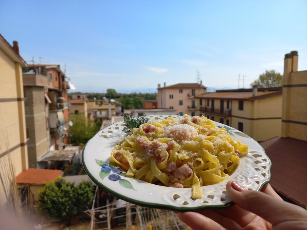 Traditional spaghetti carbonara served in Rome with guanciale, Pecorino Romano cheese, and black pepper.