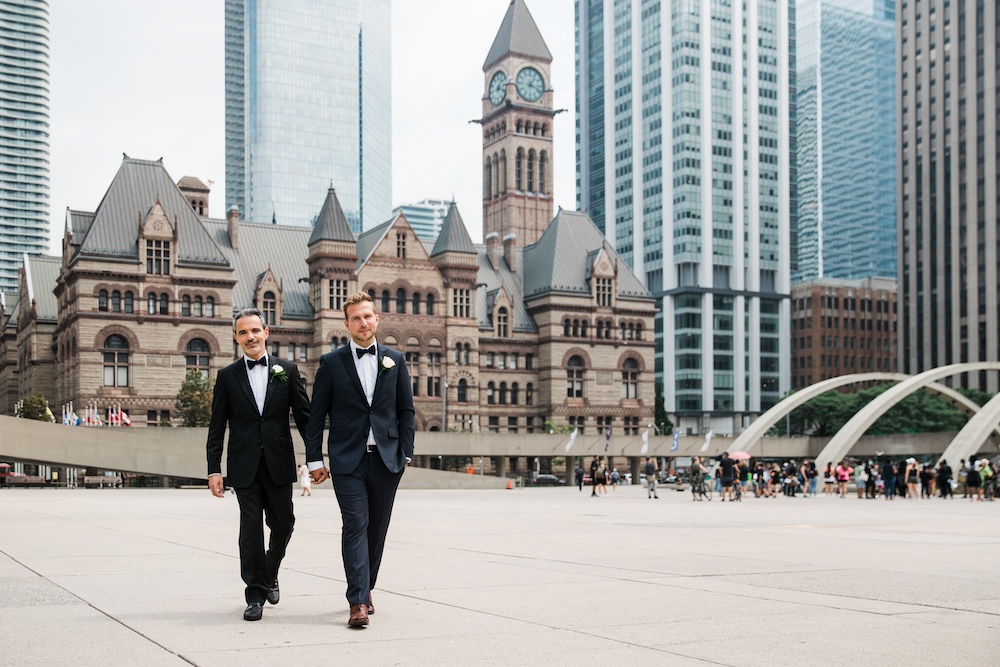 Dustin and Luigi walking from their civil wedding ceremony at Toronto City Hall
