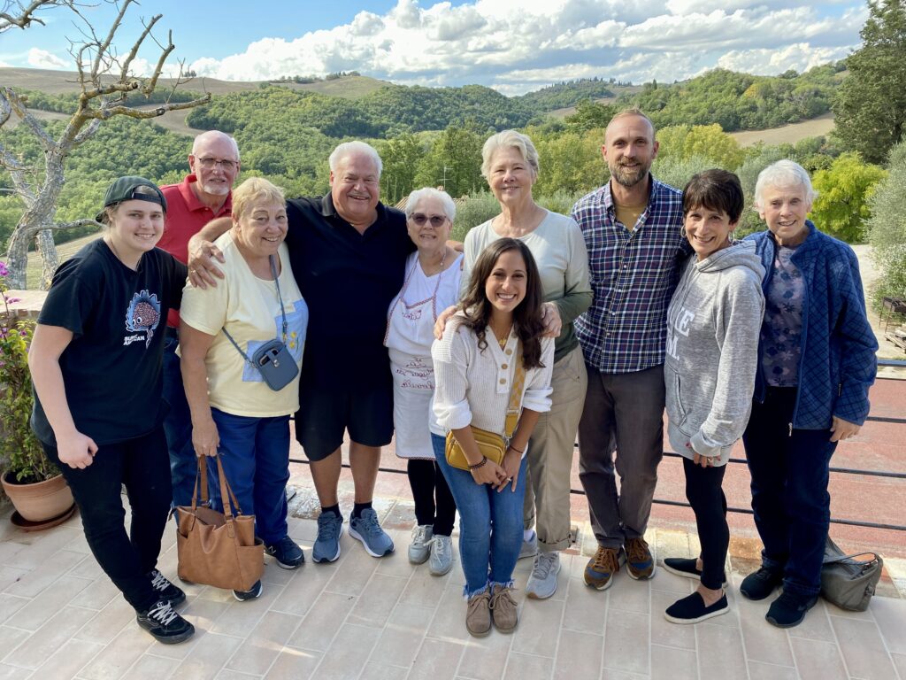 Angela Isherwood of Olive & Atlas leading a group tour at an Italian winery as part of Olive & Atlas Travel experiences.