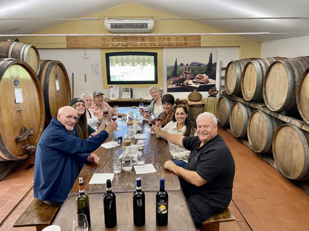 Angela Isherwood guiding guests inside an Italian winery during a wine tasting as part of Olive & Atlas Travel.