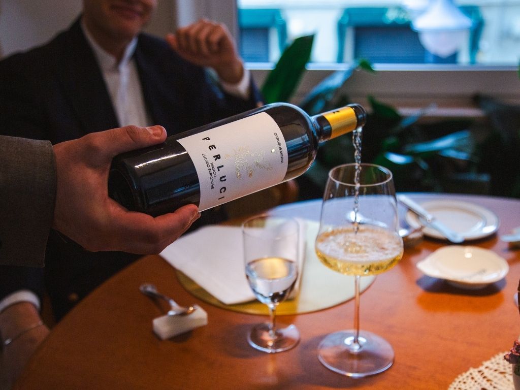 Caruso & Minini Perluci Perricone Bianco being poured into a wine glass in Sicily