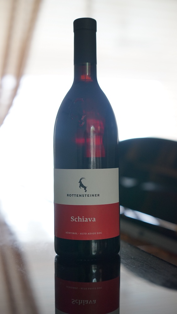 Bottle of Rottensteiner Schiava Südtirol Alto Adige DOC red wine, featuring its distinctive red and white label.