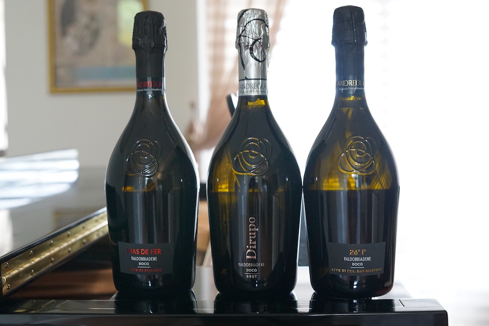 Three bottles of Andreola Valdobbiadene Prosecco Superiore DOCG sparkling wine from Veneto, Italy, including Mas de Fer, Dirupo and 26° I° Rive di Col San Martino.