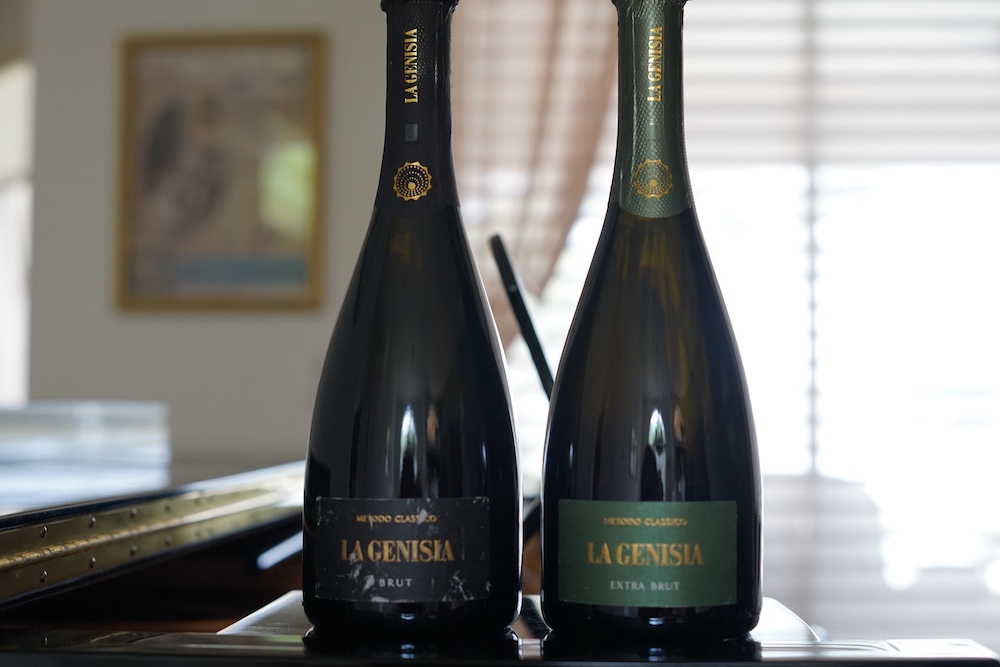 Two bottles of La Genisia Metodo Classico sparkling wine from Oltrepò Pavese, Lombardy, featuring Brut and Extra Brut varieties.