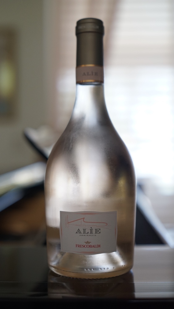 Bottle of Frescobaldi Alìe Ammiraglia rosé wine from Tenuta Ammiraglia in Maremma, Tuscany, featuring its pale pink color and frosted glass bottle.