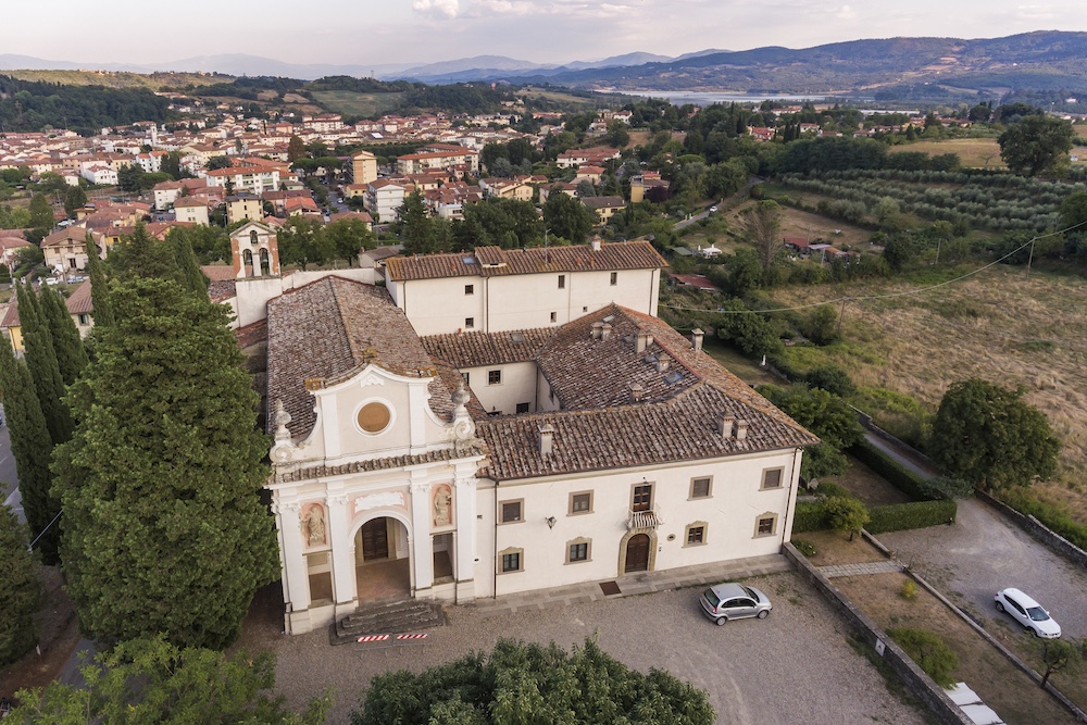 Aerial view of Badia di Santa Maria a Vigesimo, a historic abbey complex in Mugello, Tuscany, where a restored private residence is for sale.