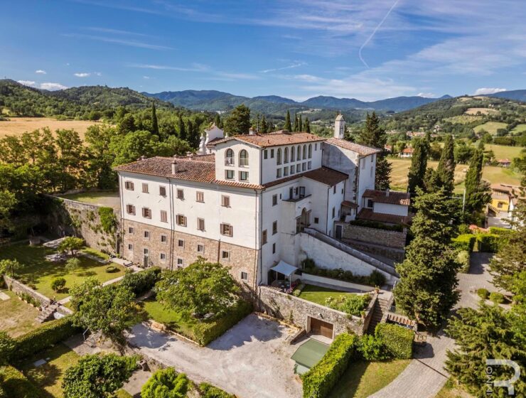 Aerial view of Badia di Santa Maria a Vigesimo showing the historic abbey buildings, terraced gardens and surrounding hills of Mugello, Tuscany.