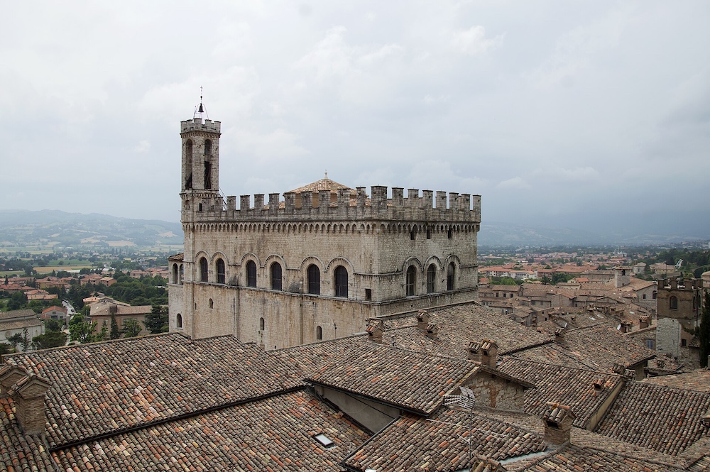 Palazzo dei Consoli overlooking the medieval rooftops of Gubbio in Umbria, Italy.