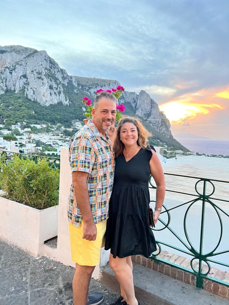 Sandy and Phil of Total Tuscany enjoying a sunset overlooking the Mediterranean Sea and dramatic cliffs of Capri, Italy.
